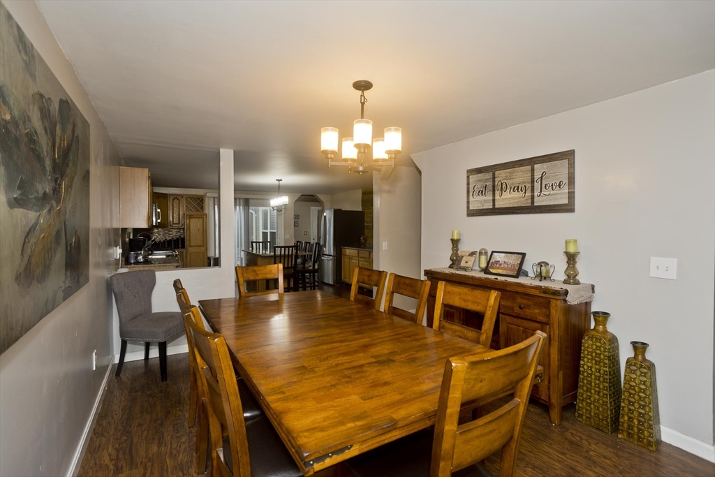 391 Plumtree Road Springfield, MA 01118 - Photo 10 of 42 a dining room with wooden floor and large window