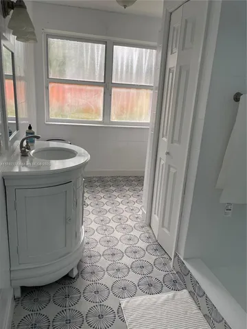a bathroom with a sink a toilet and a window