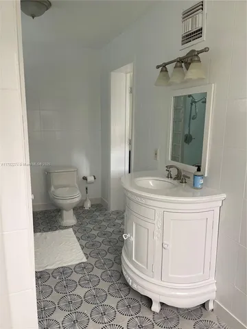a bathroom with a sink a toilet and a mirror
