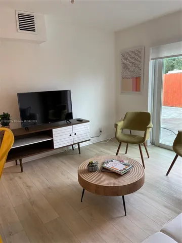 a living room with furniture and a rug