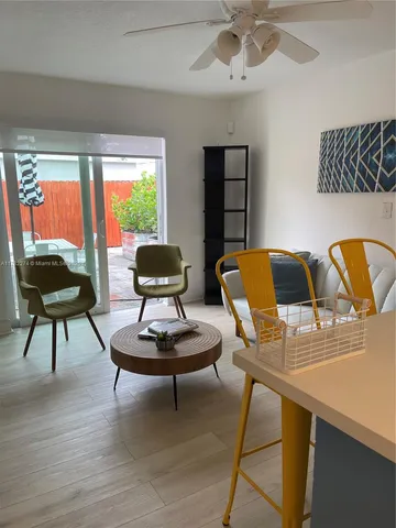 a living room with furniture and a lamp