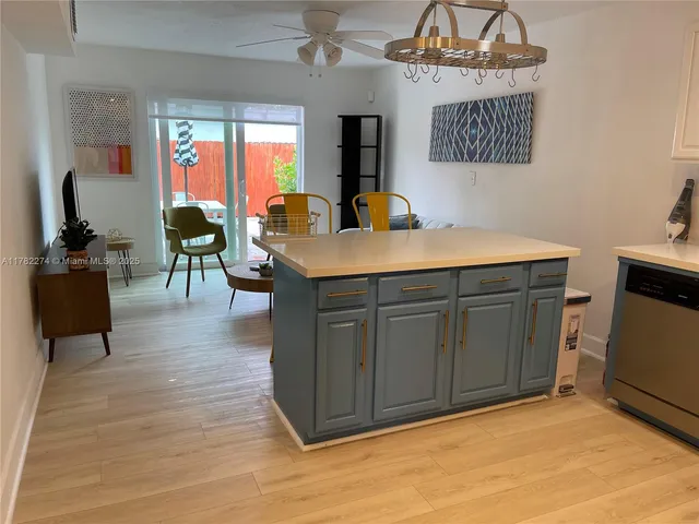 a living room with furniture a flat screen tv and a stove