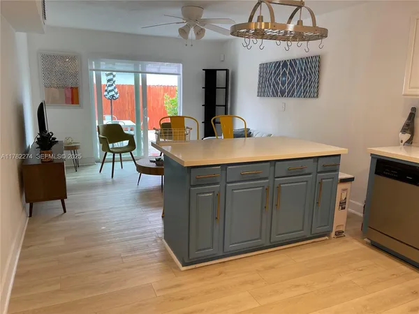 a living room with furniture a dining table and a fireplace