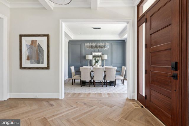a view of a hallway with wooden floor and glass door