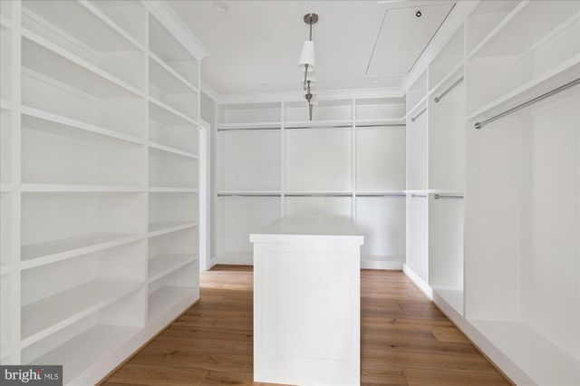 a view of cabinets a sink and a stove in a room