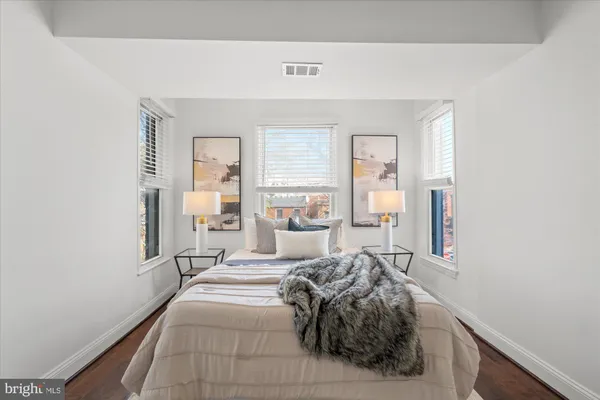 a bed room with a bed and a large mirror