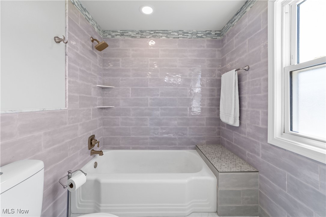 3826 Faversham Road Cleveland, OH 44118 - Photo 24 of 40 Bathroom with tile walls, shower / bath combination, and toilet