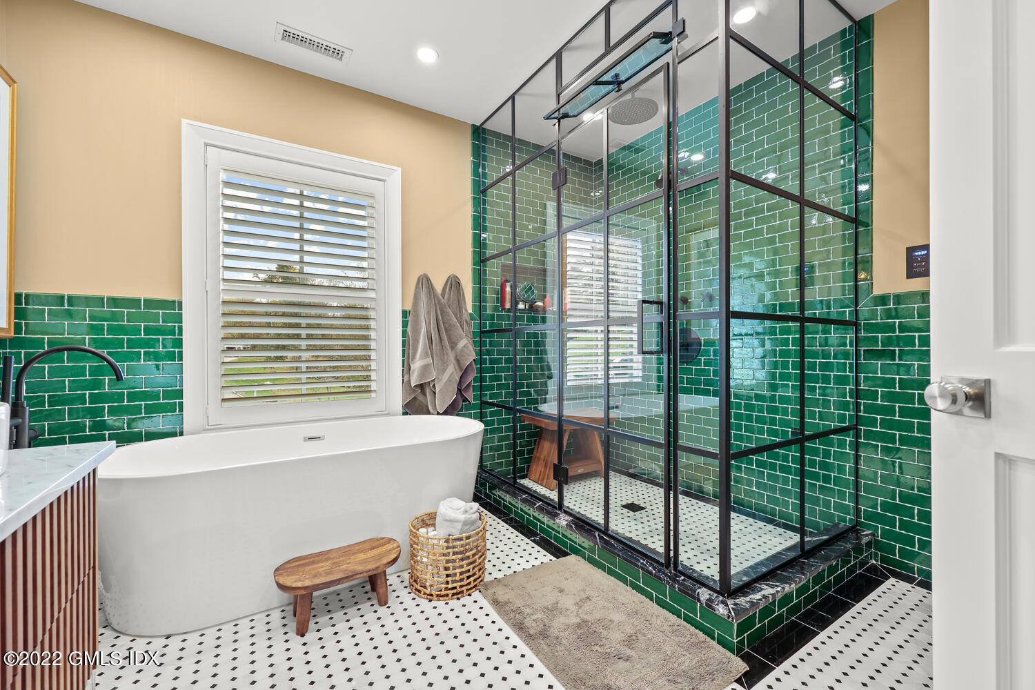 14 Copper Beech Road Greenwich, CT 06830 - Photo 30 of 48 a bathroom with a bathtub and next to a window