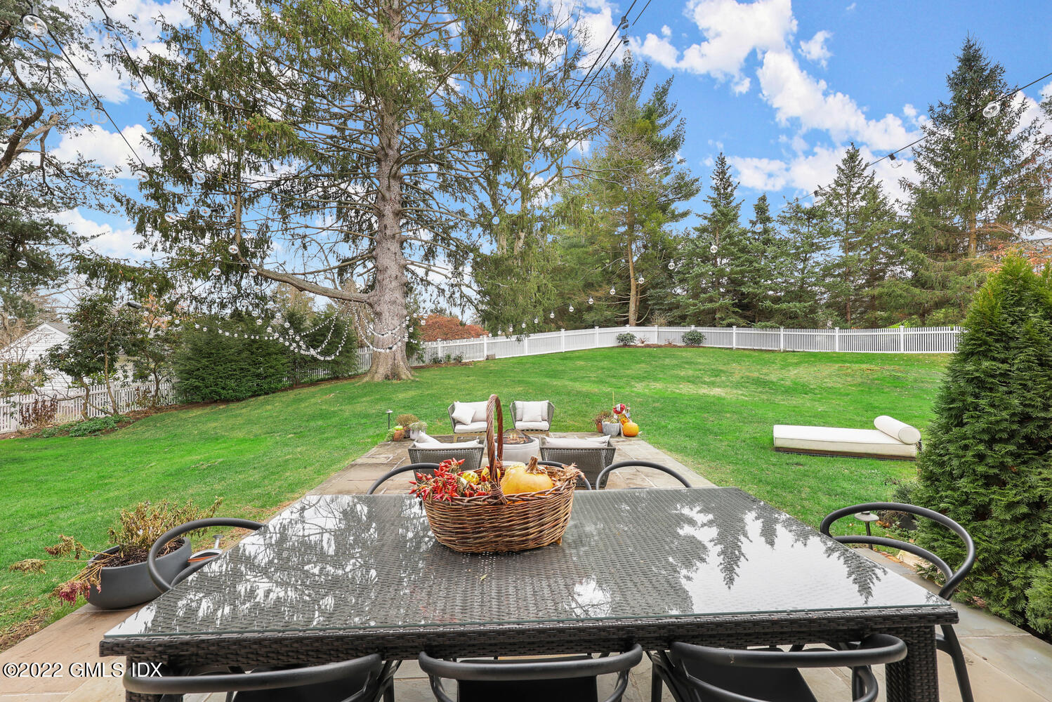 14 Copper Beech Road Greenwich, CT 06830 - Photo 41 of 48 a view of a yard with a table and chairs