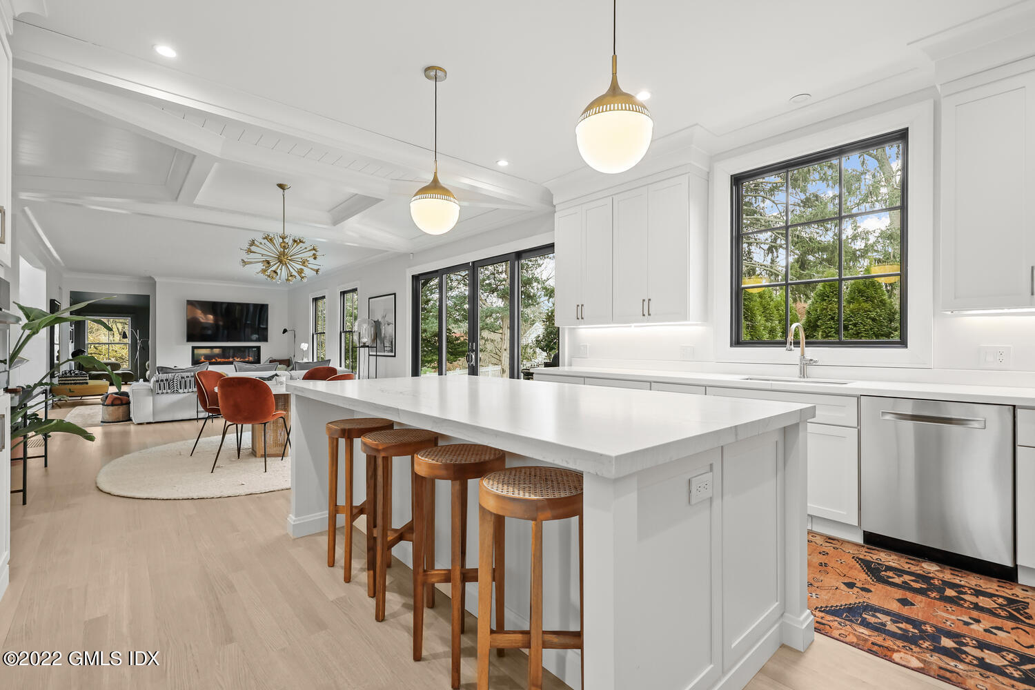 14 Copper Beech Road Greenwich, CT 06830 - Photo 9 of 48 a open kitchen with stainless steel appliances granite countertop a stove a sink a dining table and chairs with wooden floor