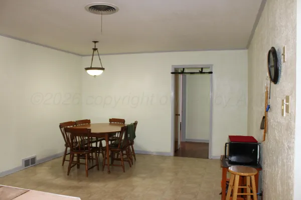 a view of a dining room with furniture and a chandelier