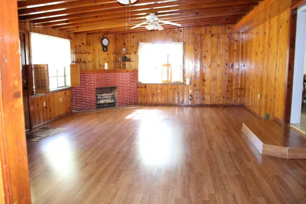 a view of a livingroom with wooden floor and a window