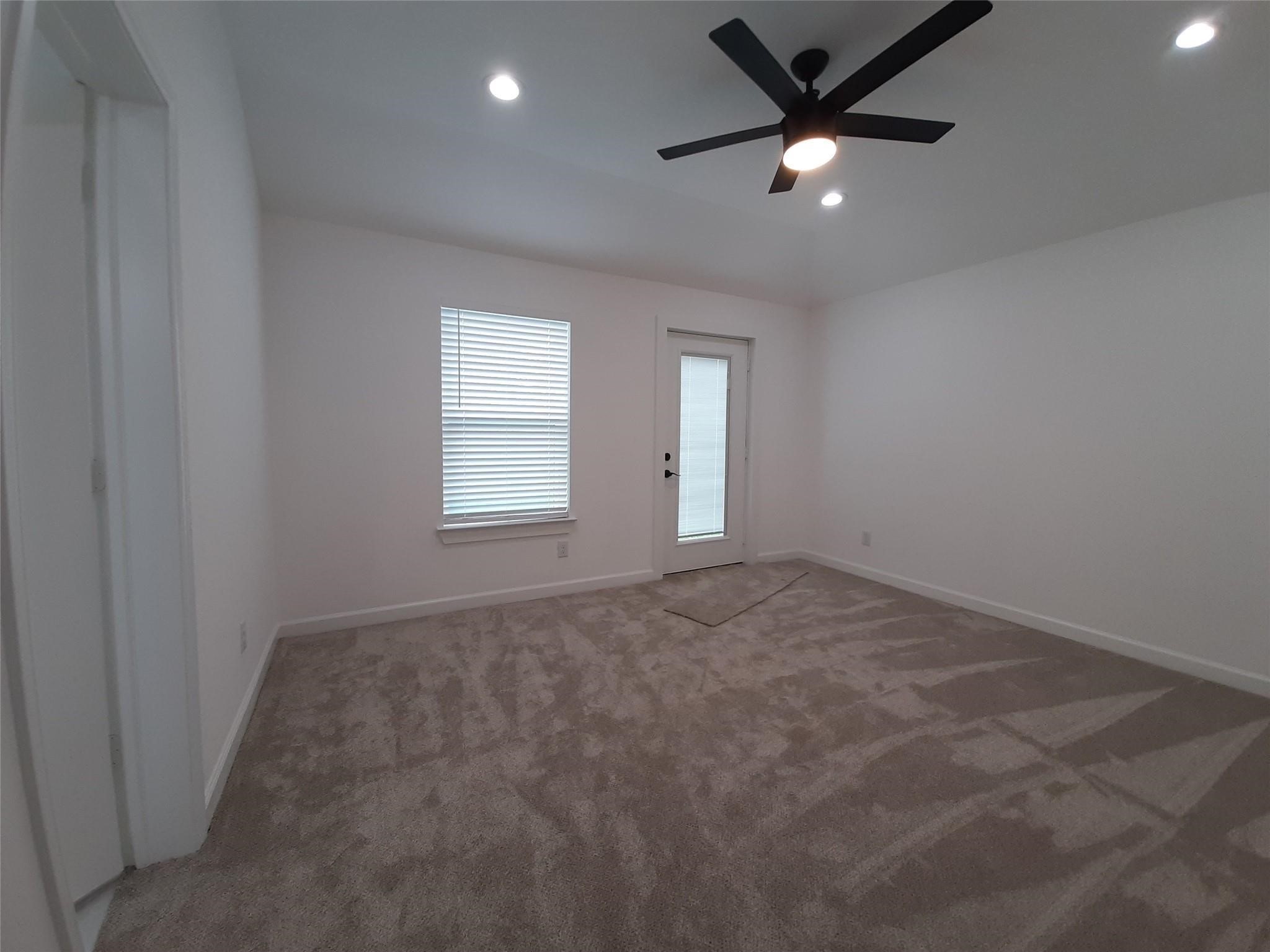 4530 Mayflower Street Houston, TX 77051 - Photo 12 of 21 an empty room with windows and a ceiling fan