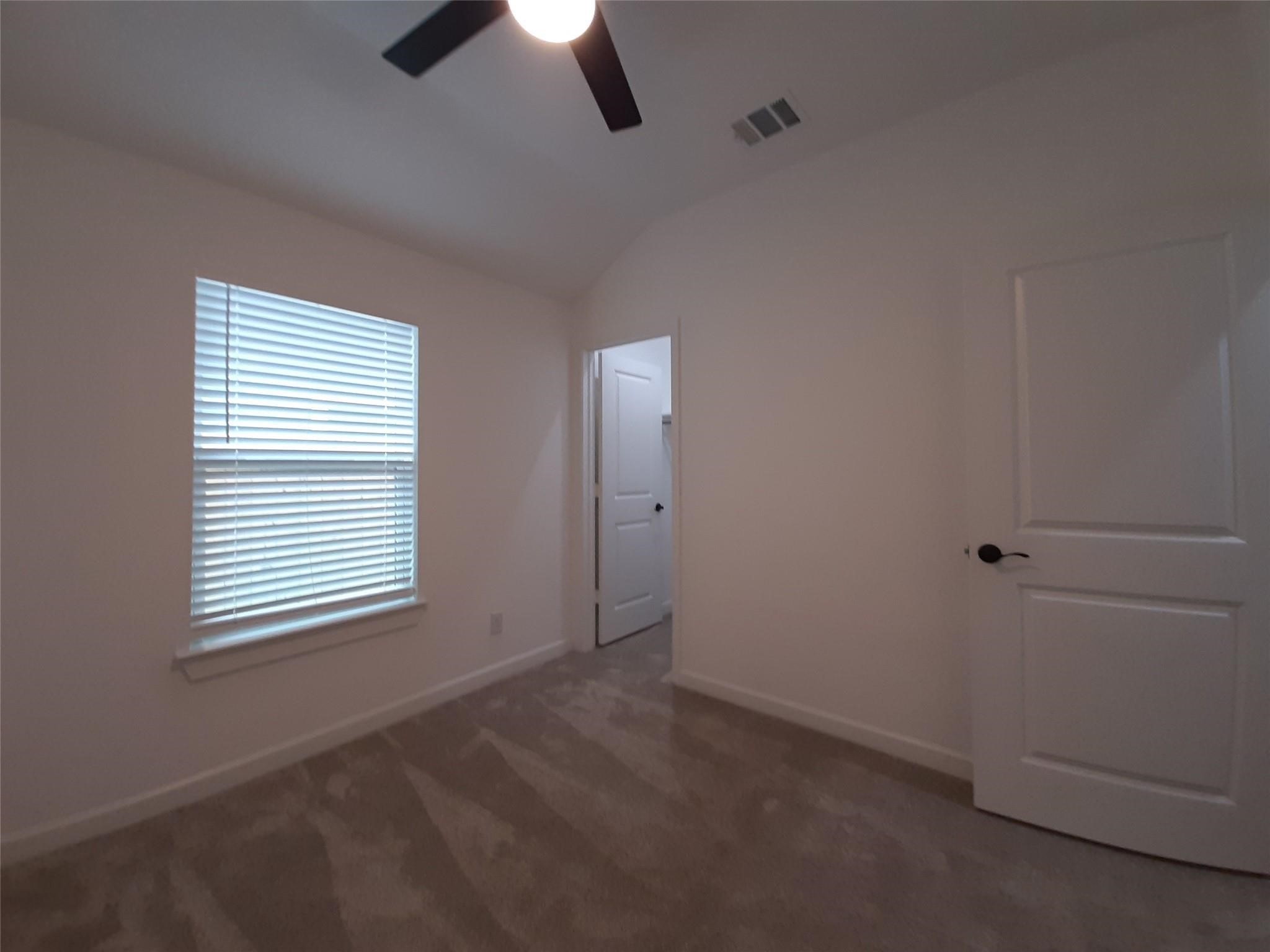 4530 Mayflower Street Houston, TX 77051 - Photo 13 of 21 an empty room with chandelier fan and windows
