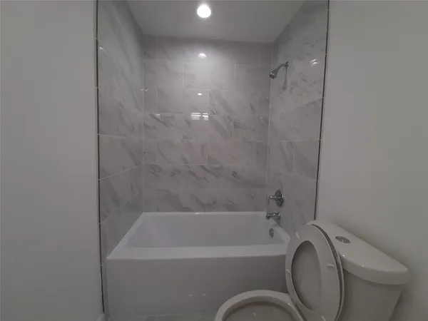 a bathroom with a bathtub and shower