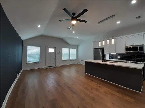 a view of kitchen with sink and wooden floor