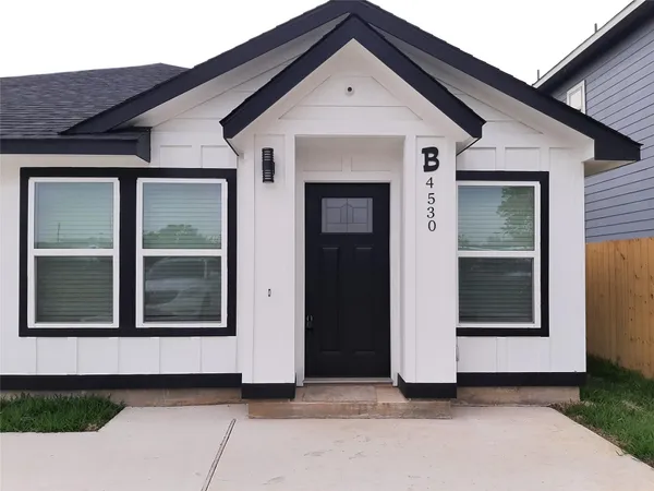 a view of a white house with large windows