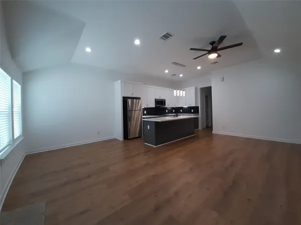 a view of kitchen with refrigerator and window