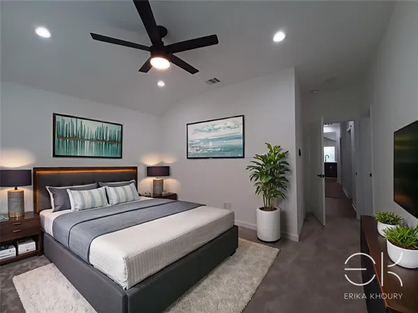 a bedroom with a bed and a potted plant