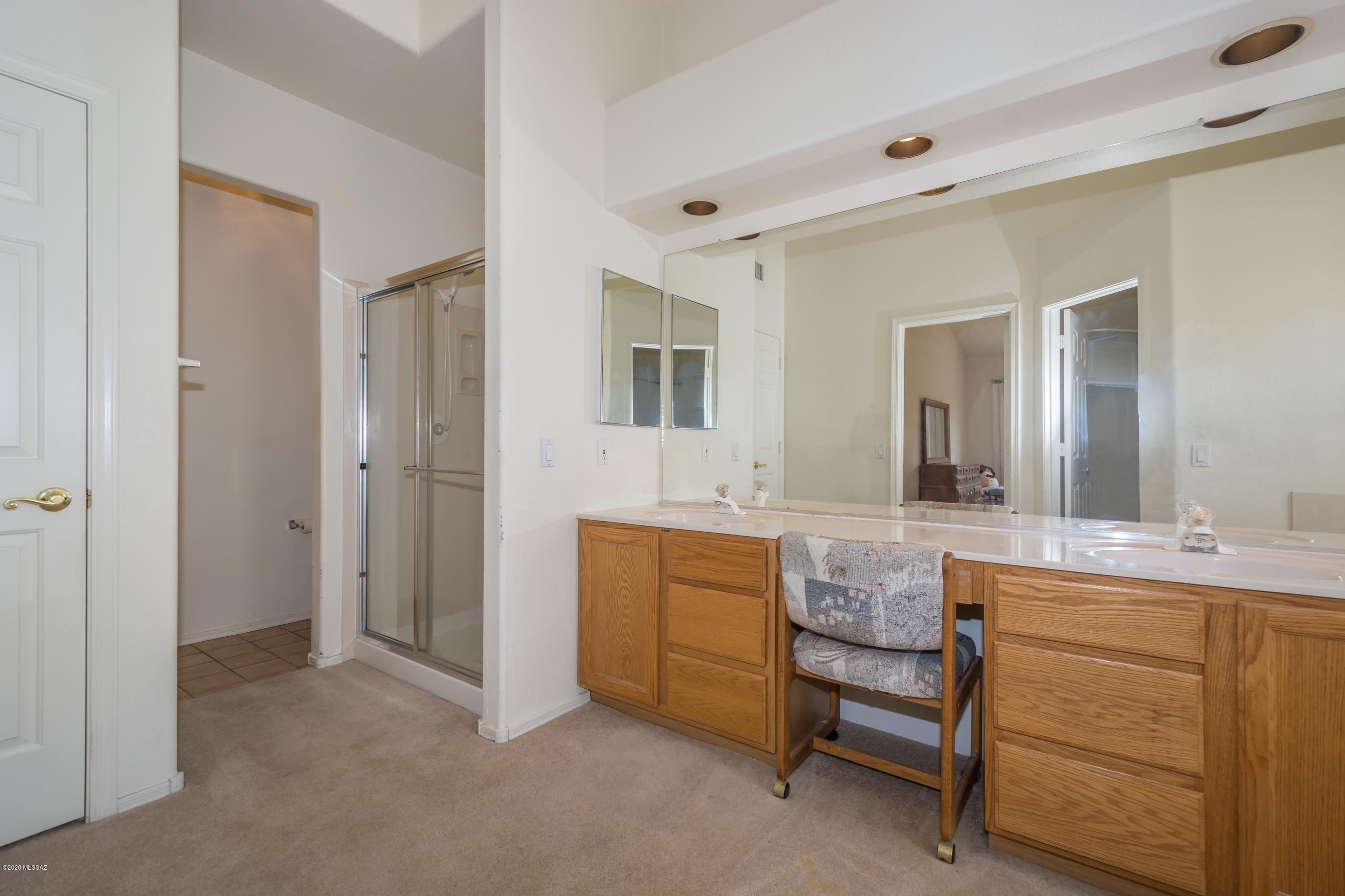 11341 Silver Pheasant Loop Oro Valley, AZ 85737 - Photo 17 of 41 a spacious bathroom with a granite countertop sink and a mirror