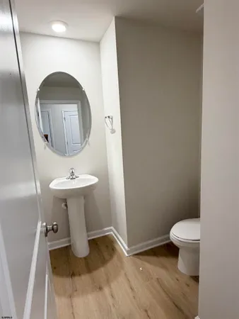 a bathroom with a sink toilet and a mirror