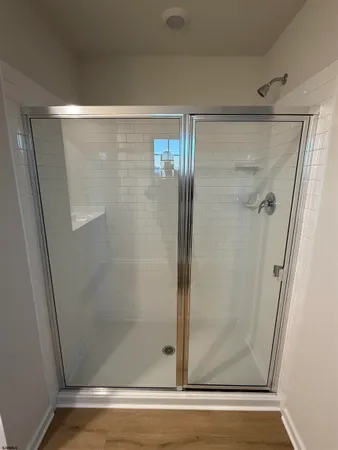 a bathroom with a glass shower door