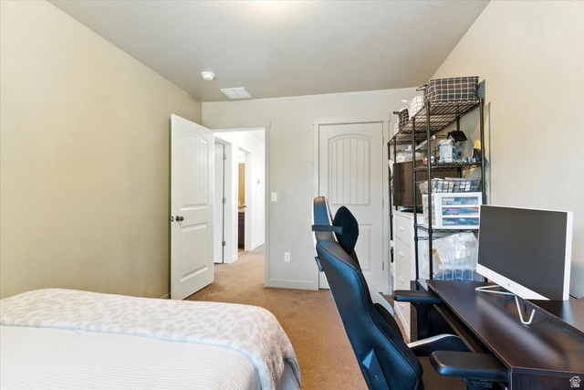 1187 Seraphim Court Layton, UT 84041 - Photo 11 of 18 Bedroom featuring a desk, light colored carpet, and a closet