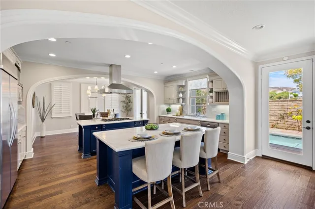a large kitchen with a table and chairs