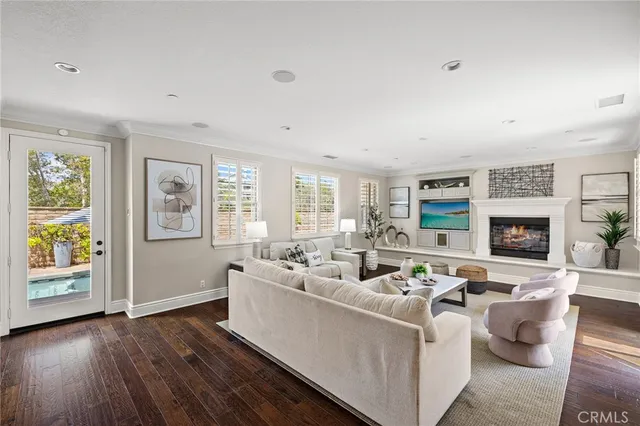 a living room with furniture wooden floor and a fireplace