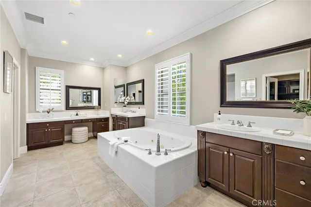 a bathroom with a tub a sink and mirror
