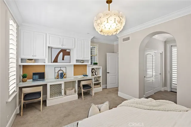 a bedroom with furniture and a chandelier