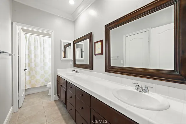 a bathroom with 2 sink and a mirror