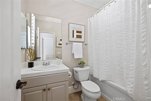 a bathroom with a sink toilet and mirror