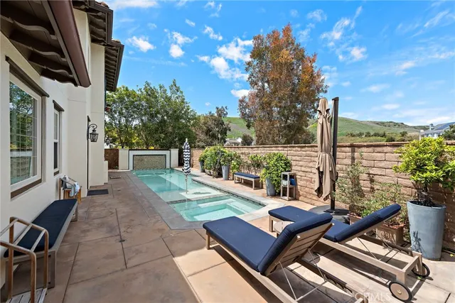 a view of a patio with furniture and a yard