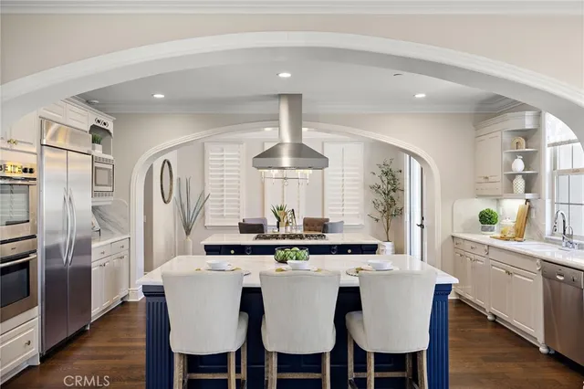 a view of a dining room with furniture a chandelier and wooden floor