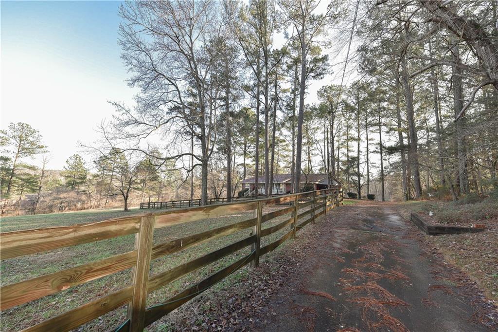 8985 Clark Road Fairburn, GA 30213 - Photo 1 of 1 a view of a yard with an trees