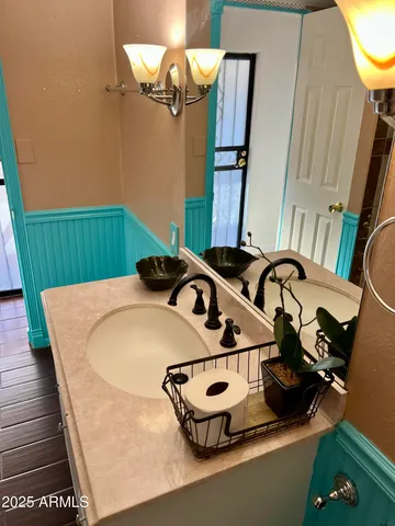 a bathroom with a sink and mirror