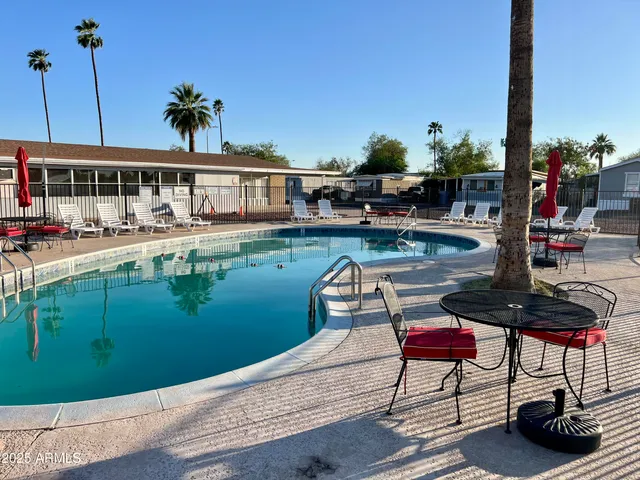a view of house with swimming pool outdoor seating