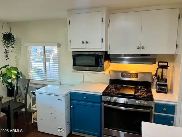 a kitchen with a stove and a microwave