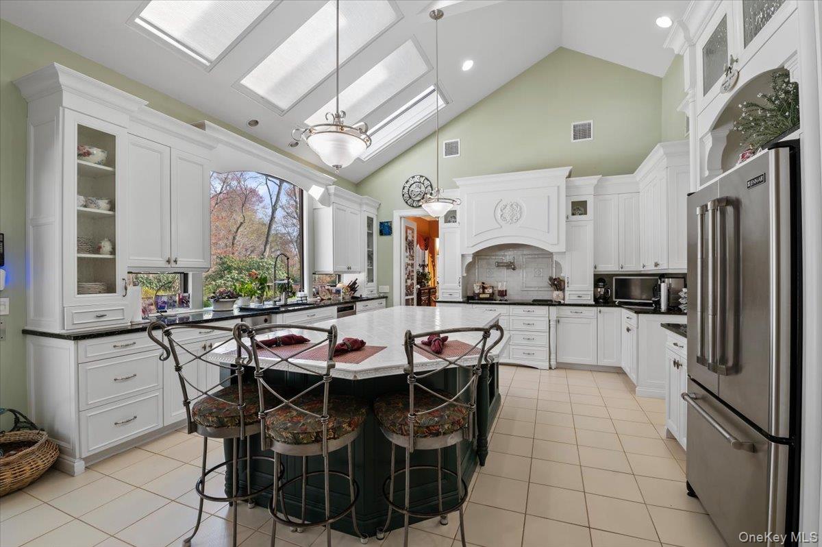 45 Coves Run Syosset, NY 11791 - Photo 11 of 43 a kitchen with a sink refrigerator and cabinets