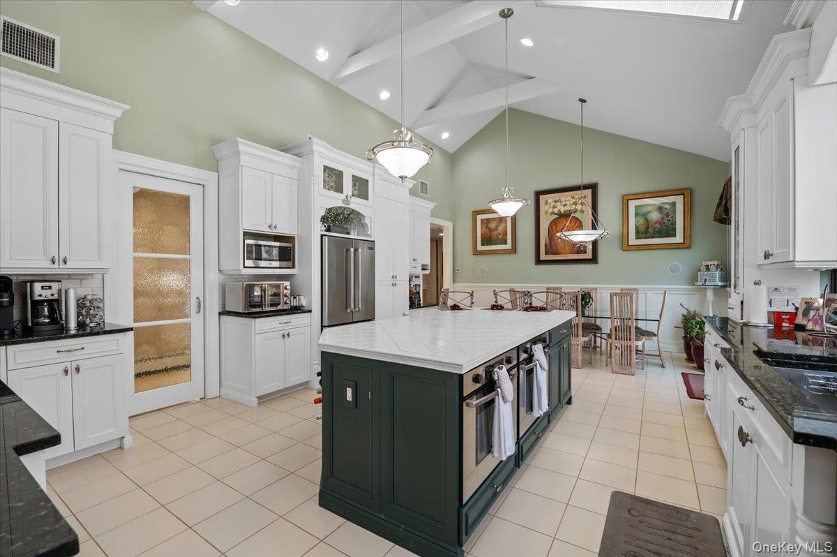 45 Coves Run Syosset, NY 11791 - Photo 13 of 43 a kitchen with stainless steel appliances a stove top oven