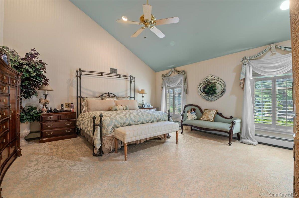 45 Coves Run Syosset, NY 11791 - Photo 17 of 43 a bedroom with a bed and a chandelier