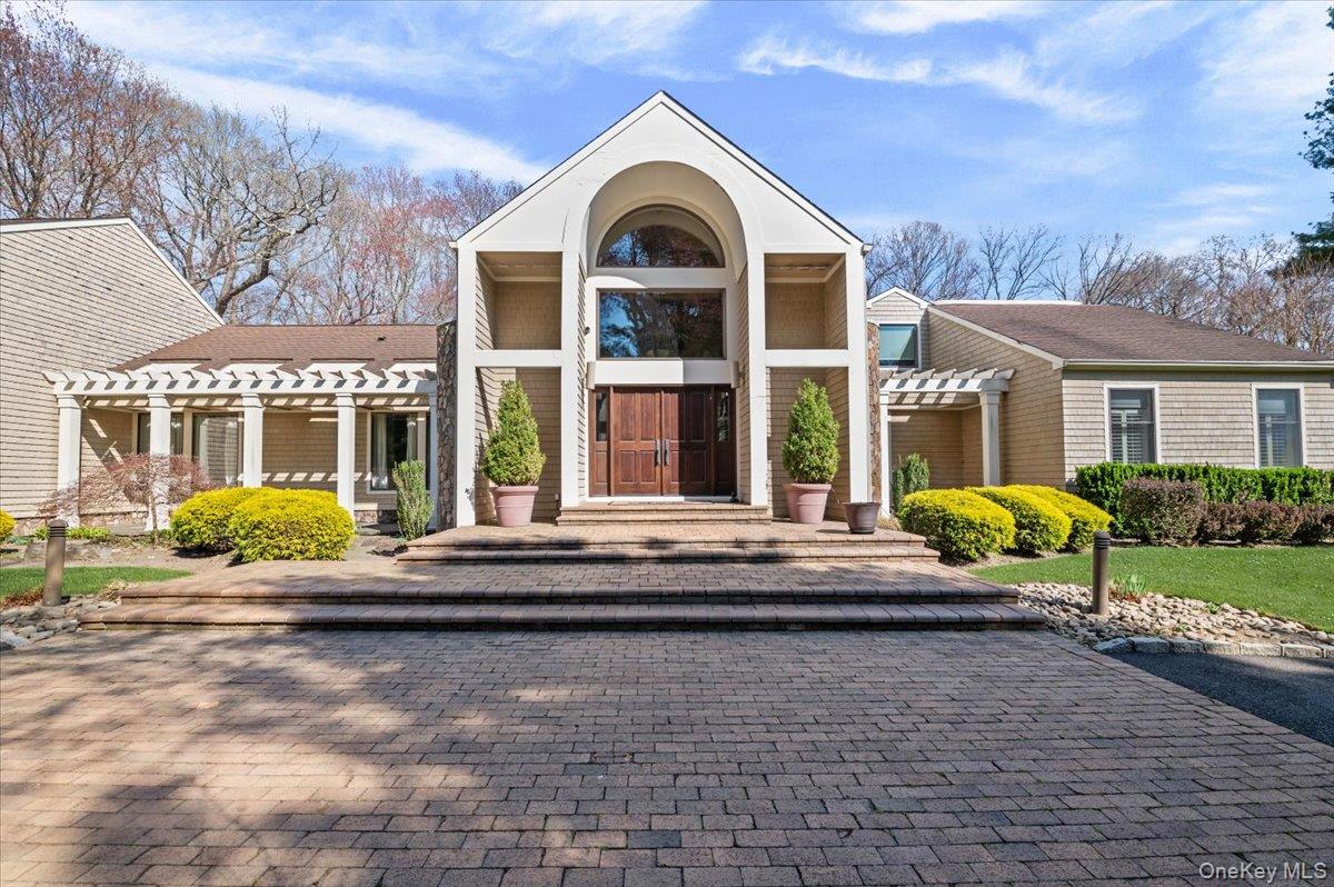 45 Coves Run Syosset, NY 11791 - Photo 2 of 43 a front view of a house with a garden