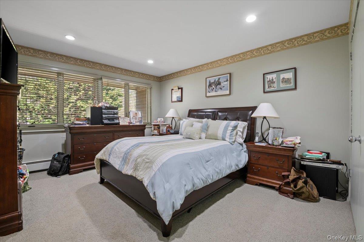 45 Coves Run Syosset, NY 11791 - Photo 27 of 43 a bedroom with a bed and a tv