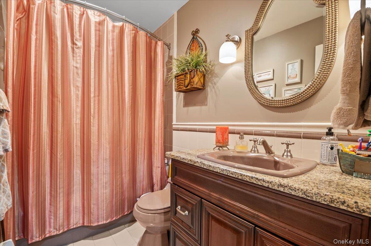 45 Coves Run Syosset, NY 11791 - Photo 28 of 43 a bathroom with a granite countertop sink and a mirror
