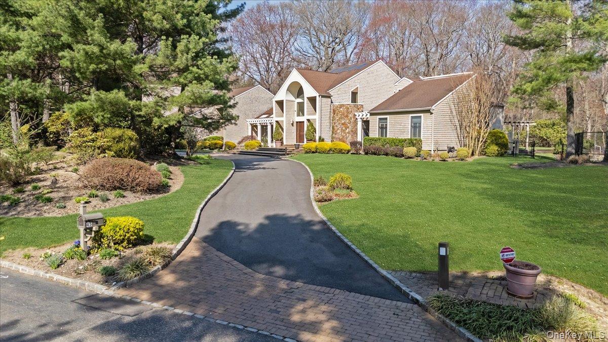 45 Coves Run Syosset, NY 11791 - Photo 3 of 43 a front view of a house with a yard and potted plants
