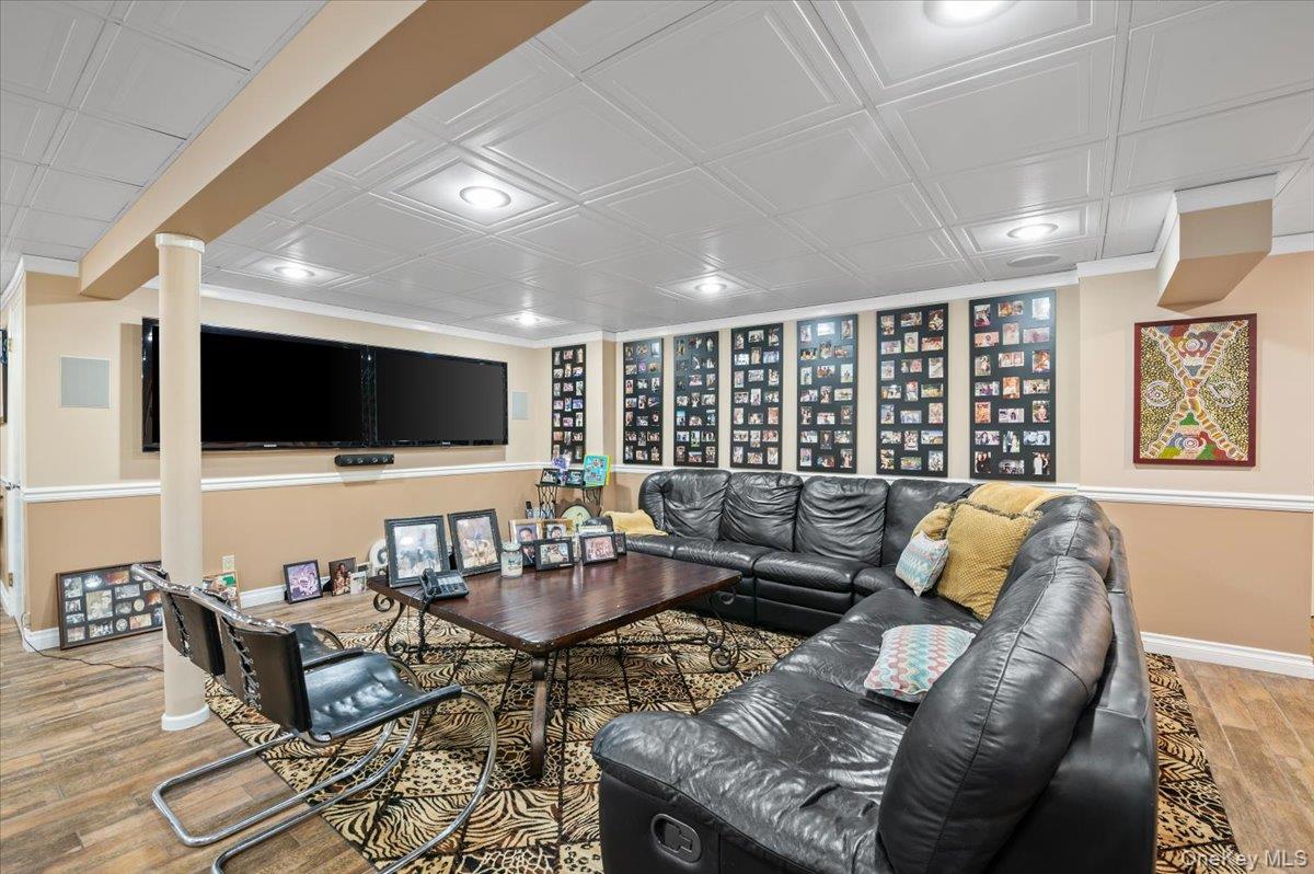 45 Coves Run Syosset, NY 11791 - Photo 31 of 43 a living room with furniture and a flat screen tv