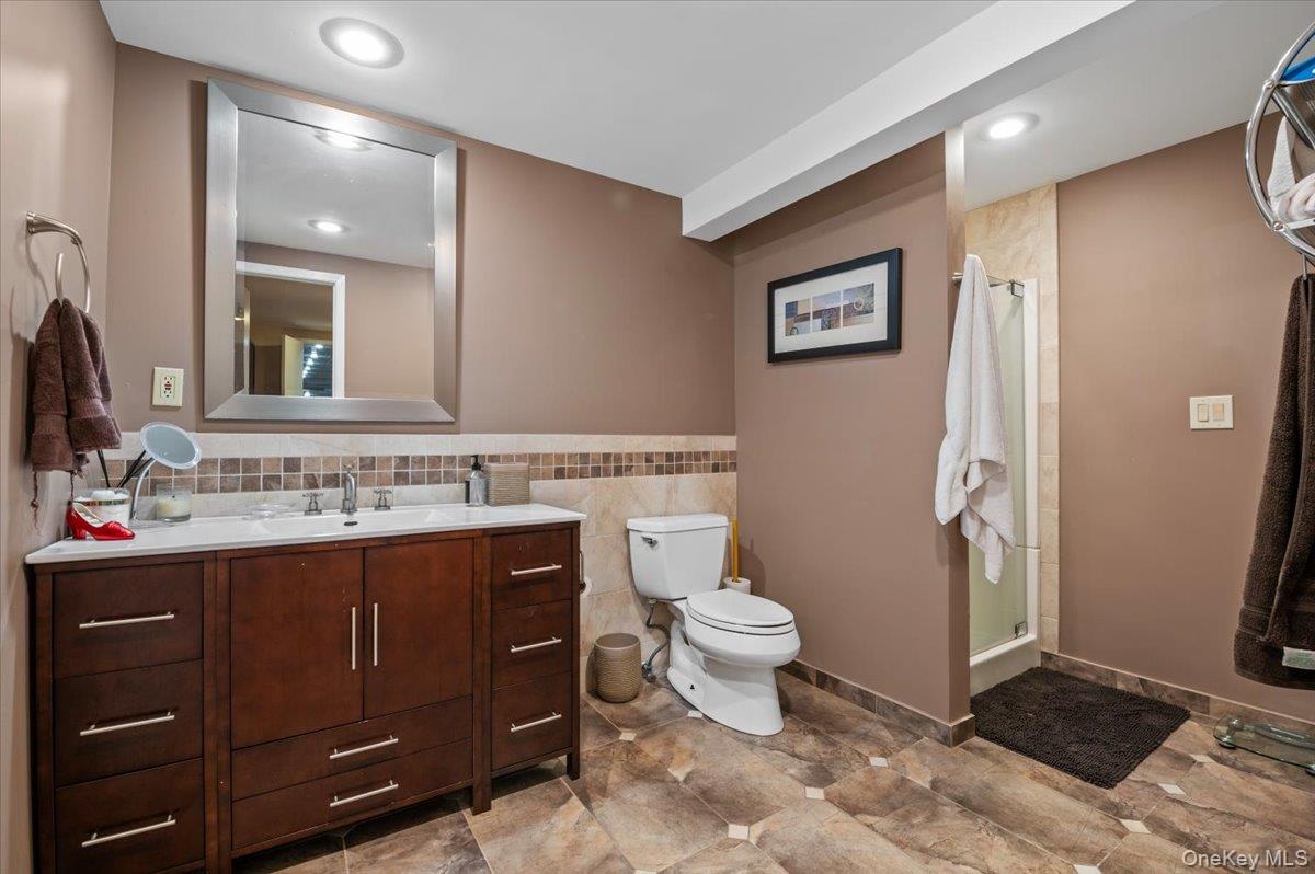 45 Coves Run Syosset, NY 11791 - Photo 33 of 43 a view of bathroom with a toilet sink and mirror
