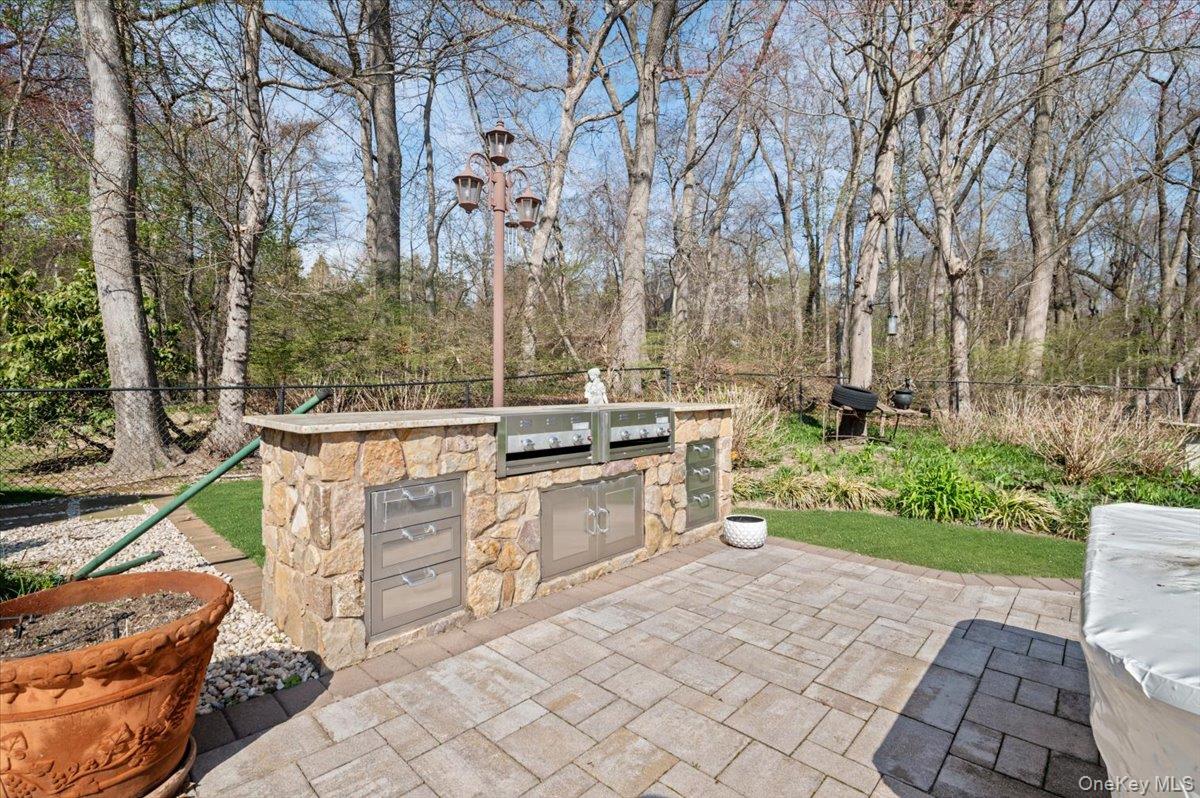 45 Coves Run Syosset, NY 11791 - Photo 37 of 43 a view of a chairs and table in backyard