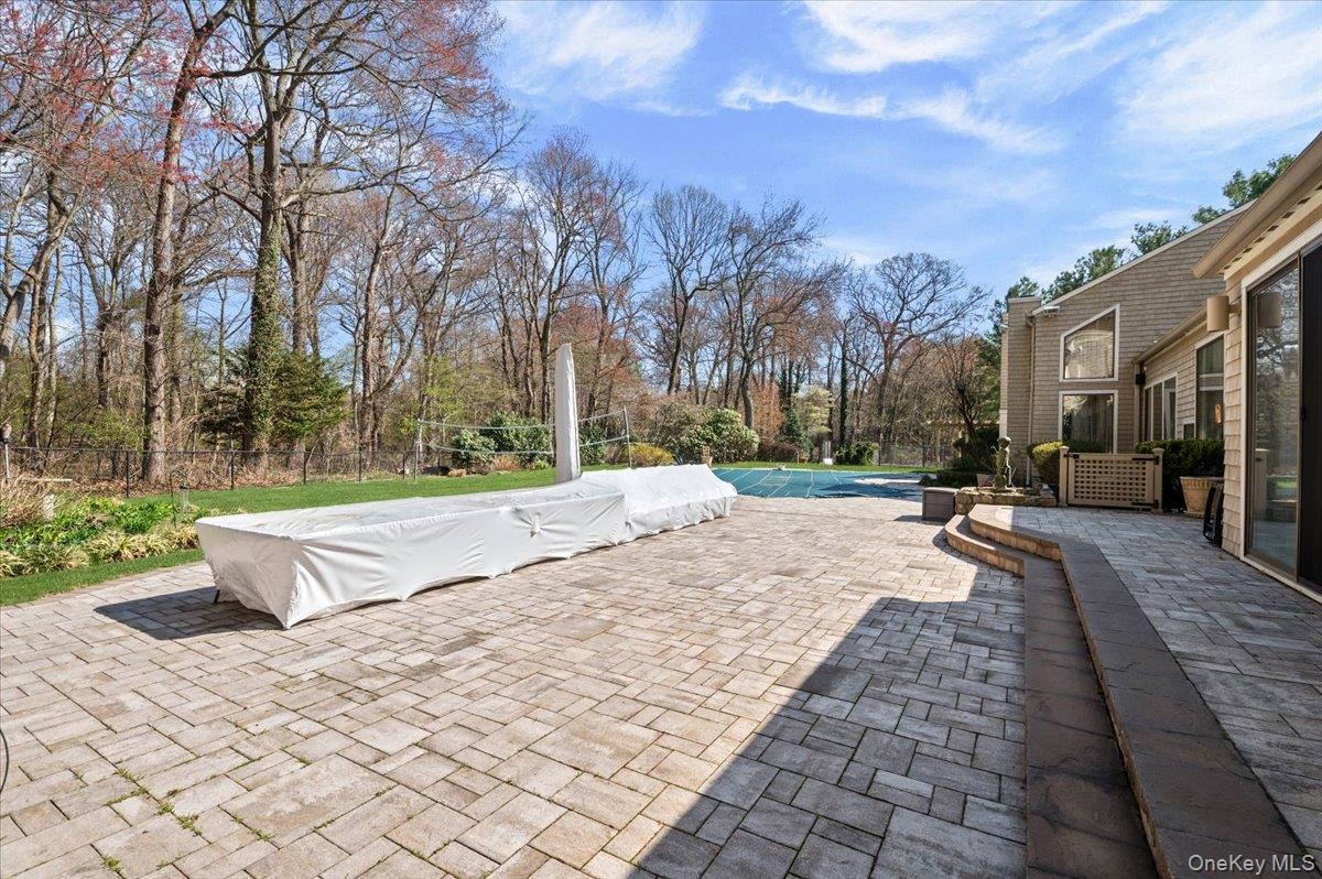 45 Coves Run Syosset, NY 11791 - Photo 38 of 43 a view of swimming pool with brick wall and plants